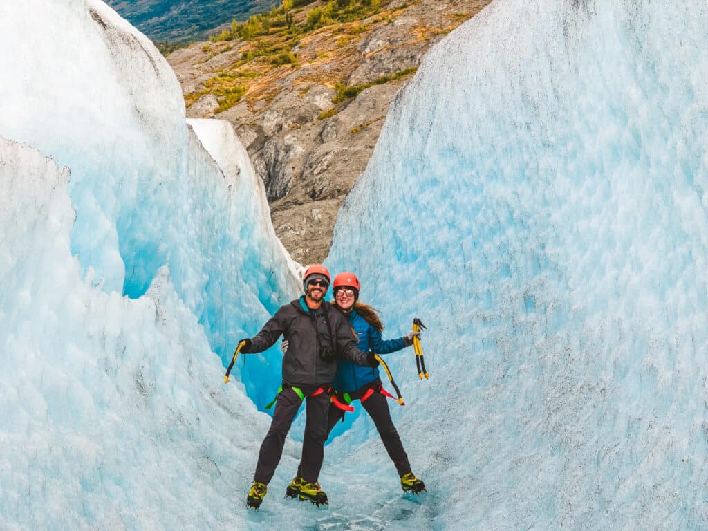 a couple with ice climbing gear on the knik glacier
