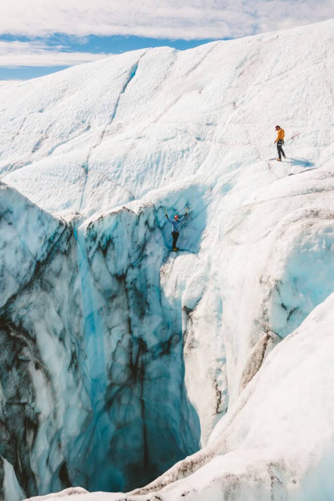 ice climber climbing out of moulin on the knik glacier